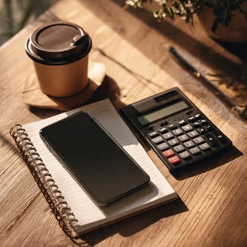 Phone with calculator and notepad calculating effective deal price