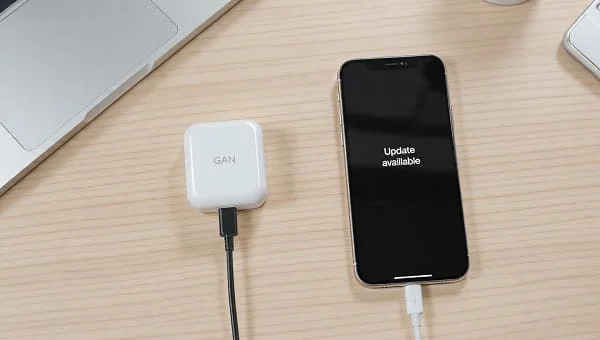 iPhone connected to charger with update available banner