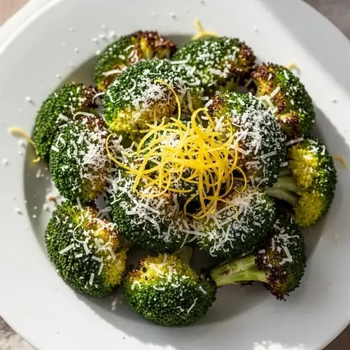 Air fryer roasted broccoli with parmesan and lemon zest on a plate