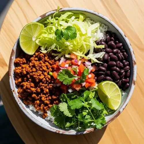 Taco rice bowls with ground meat, beans, lettuce, and salsa for a quick weeknight dinner