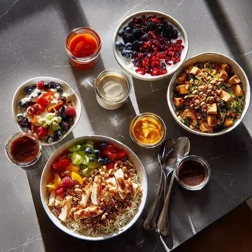 High protein meal ideas including chicken bowls, yogurt, beans, and roasted vegetables
