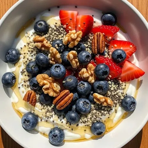 Greek yogurt high-protein breakfast bowl with berries, nuts, and seeds