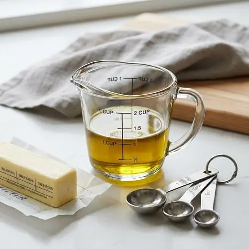 Measuring cup showing the butter to oil conversion ratio for baking